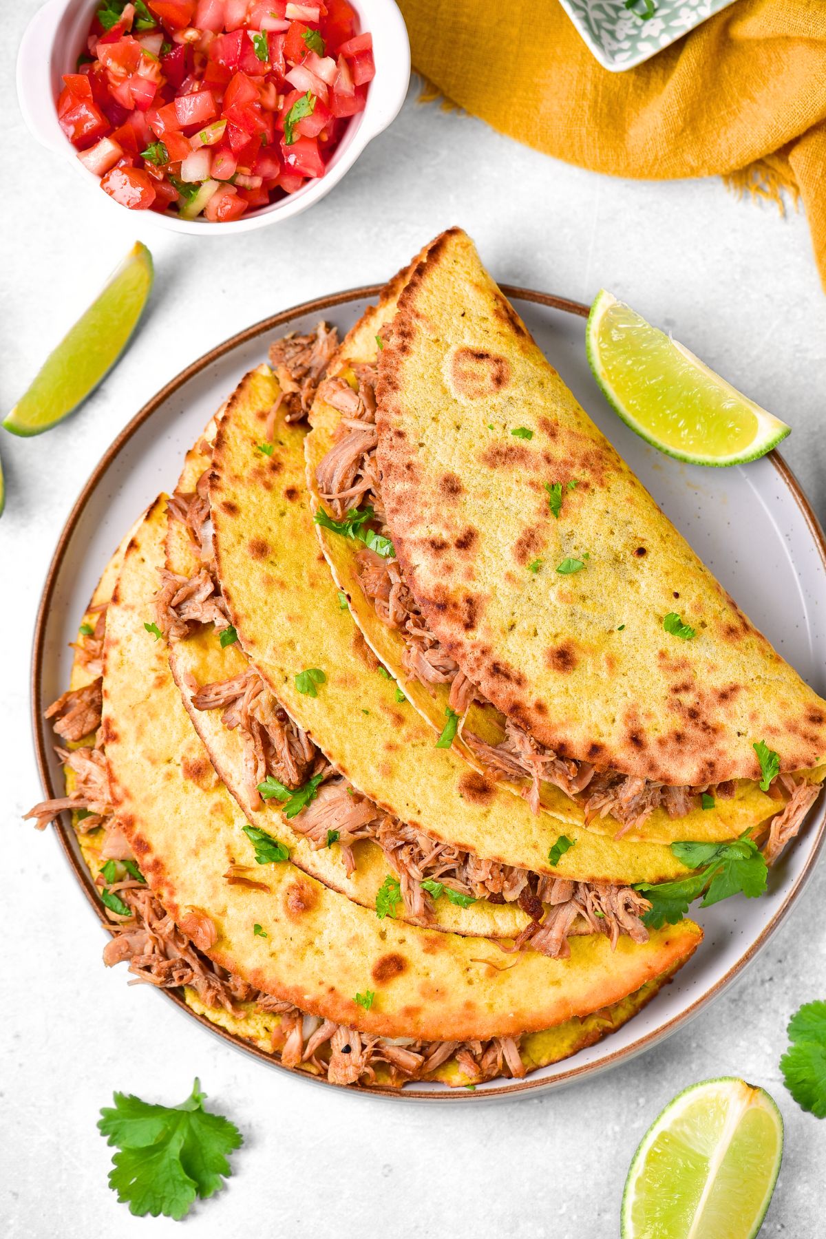 Top down view of pork tacos on plate.