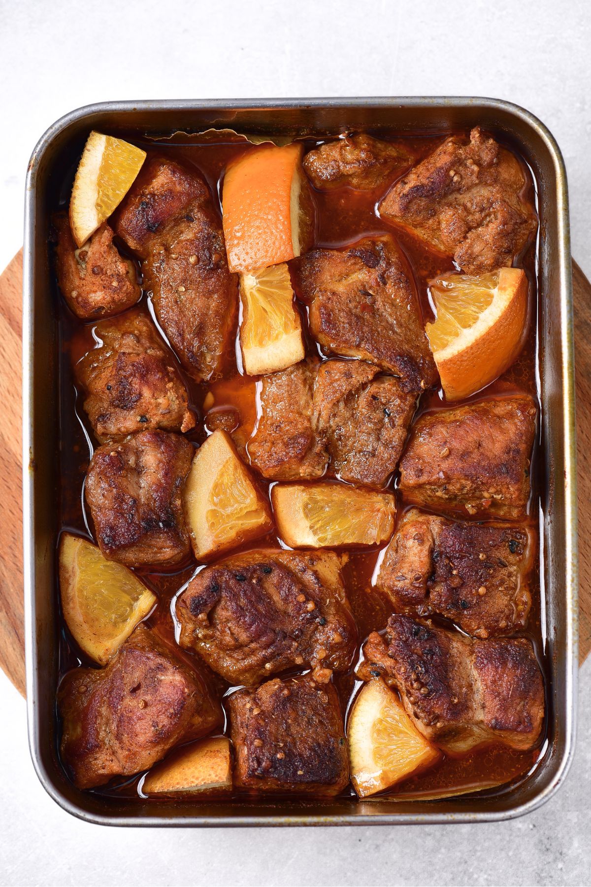 Slow roasted pork shoulder in roasting pan.