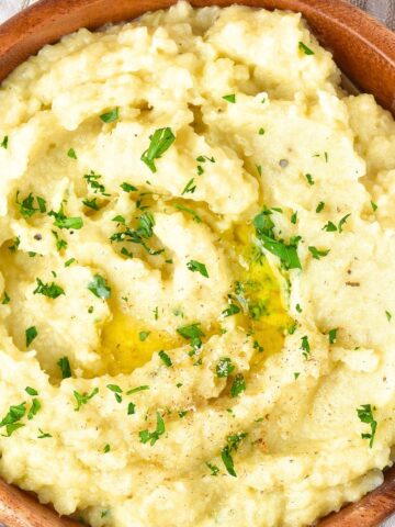 Top down view of mashed potatoes topped with chopped parsley
