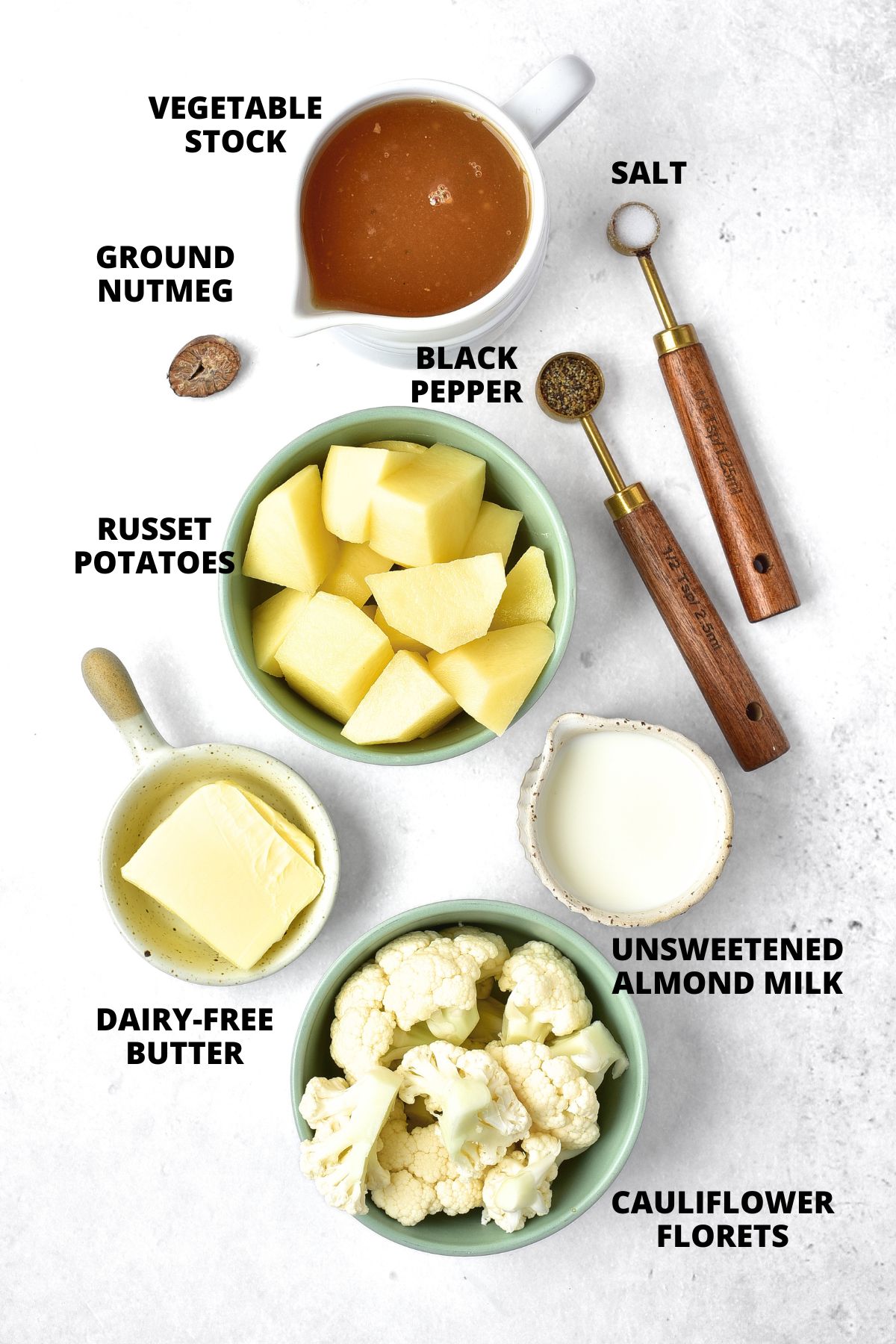Ingredients for cauliflower and potato mashed potatoes recipe laid out on marble board
