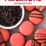 A bowl of chocolate chips and cherry chocolate macarons.
