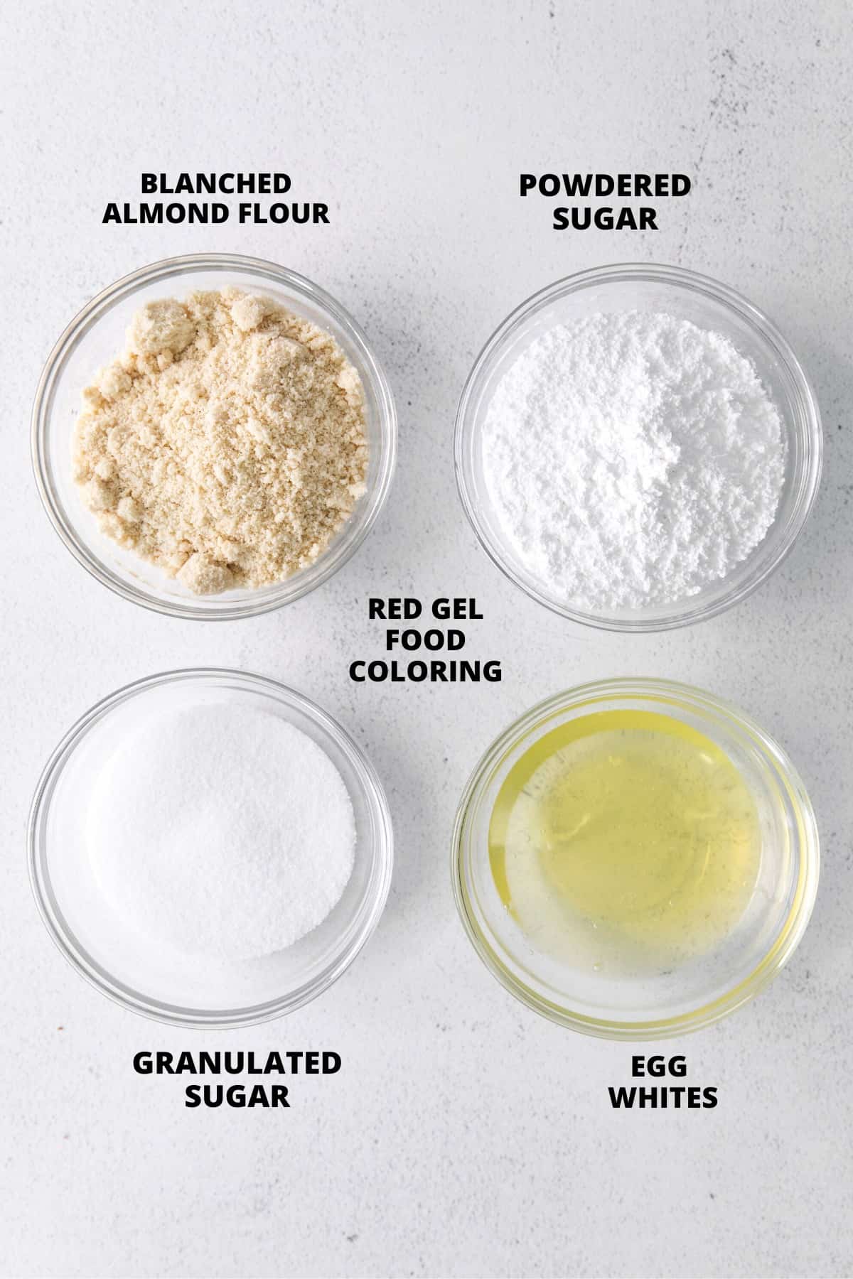 Ingredients for gluten-free macaron shells laid out on board.