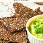 Up close view of guacamole and chia flax crackers.