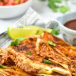 Tacos on a parchment-lined plate.