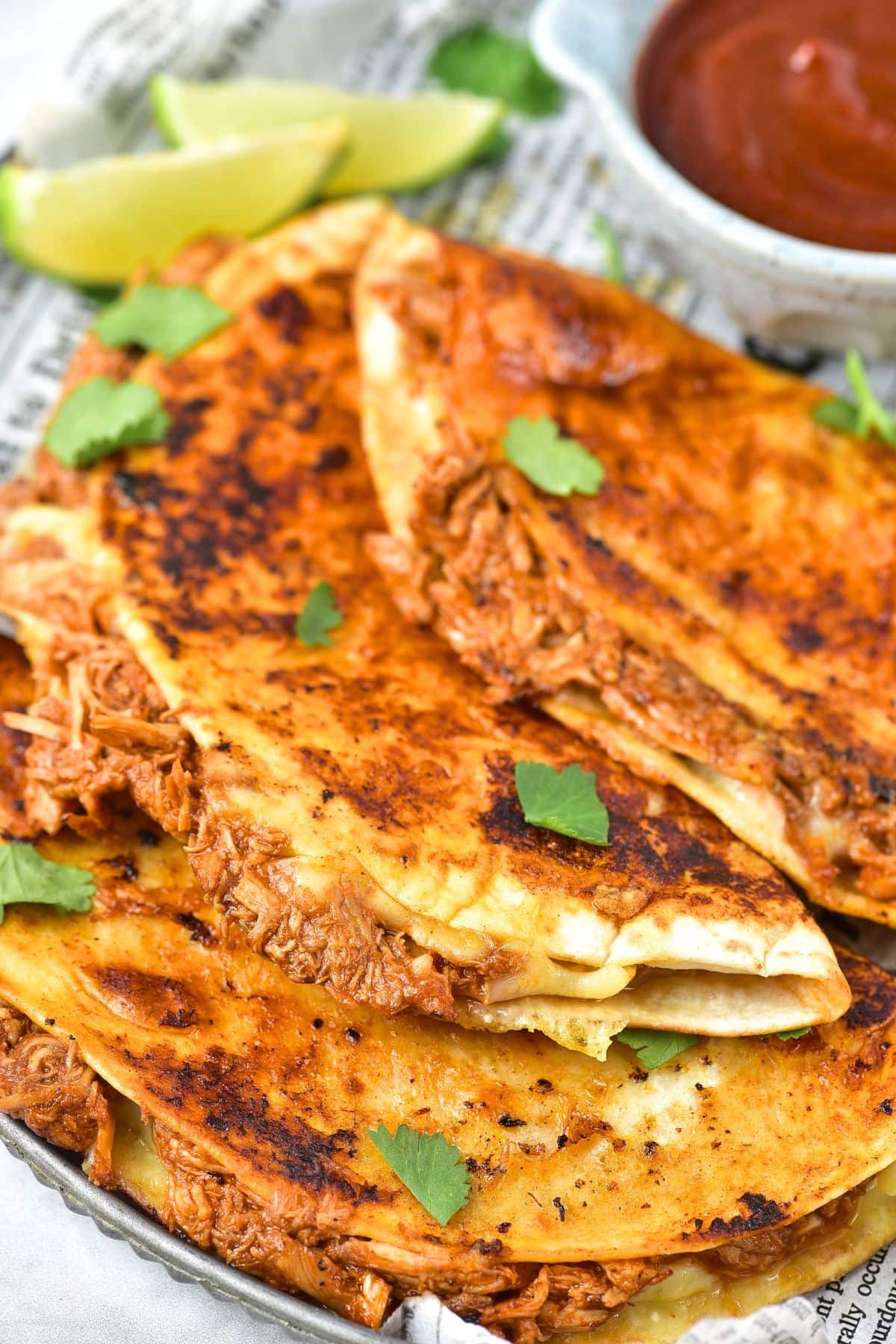 Up close view of birria chicken tacos on a plate.