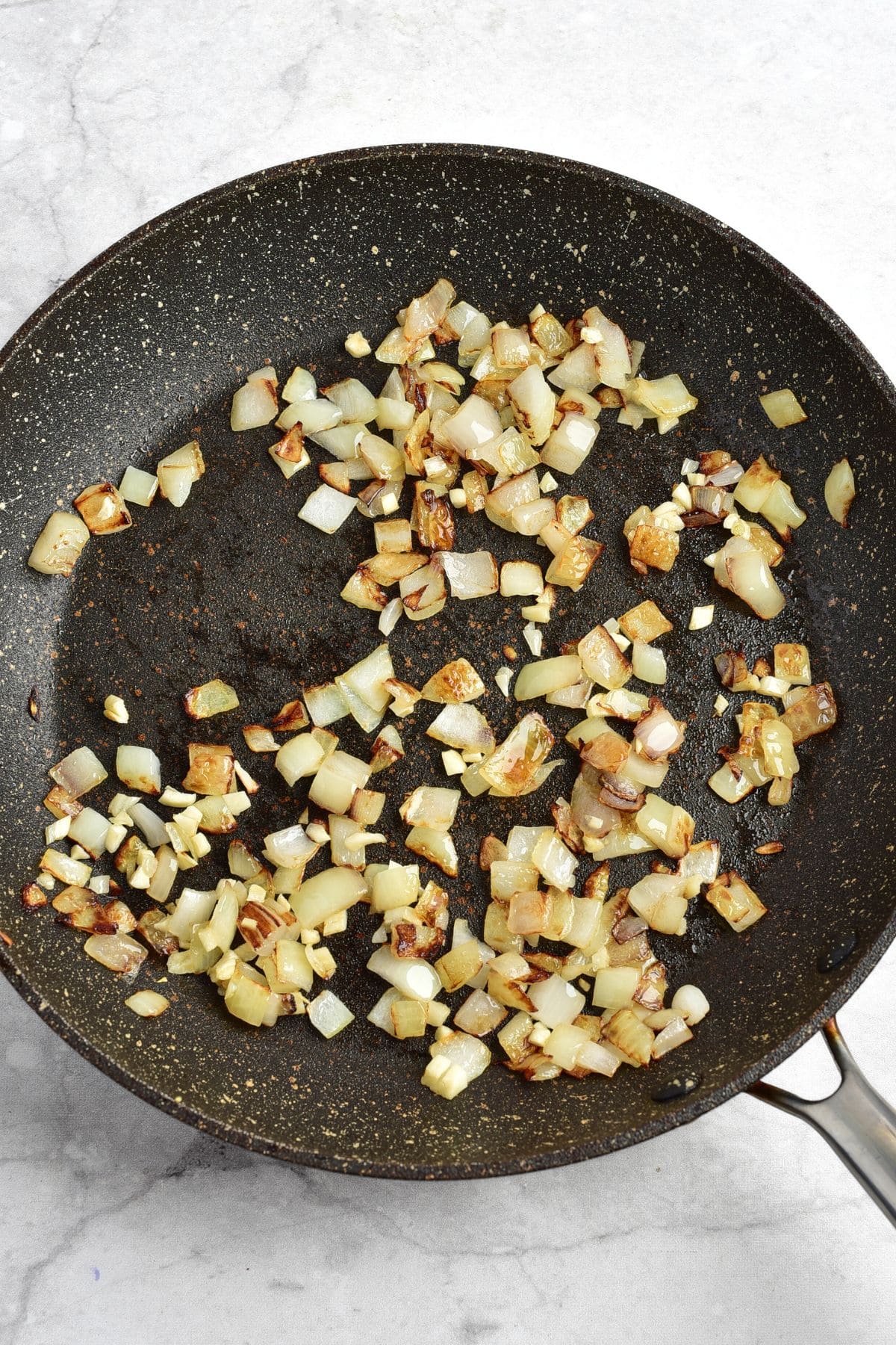Sautéed diced onions in skillet