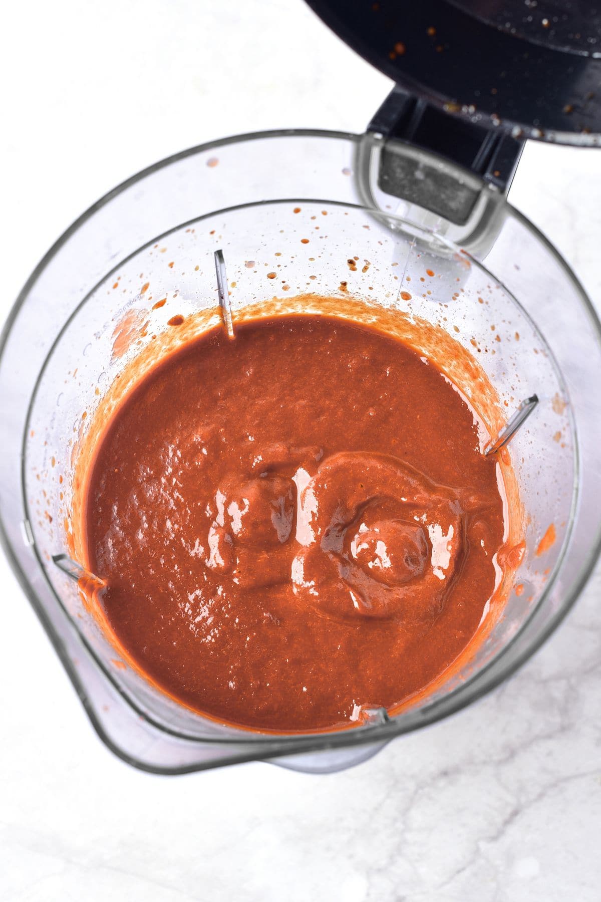 Processed birria sauce in electric blender.