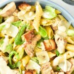 Top down view of a bowl with chicken pasta salad with caesar dressing