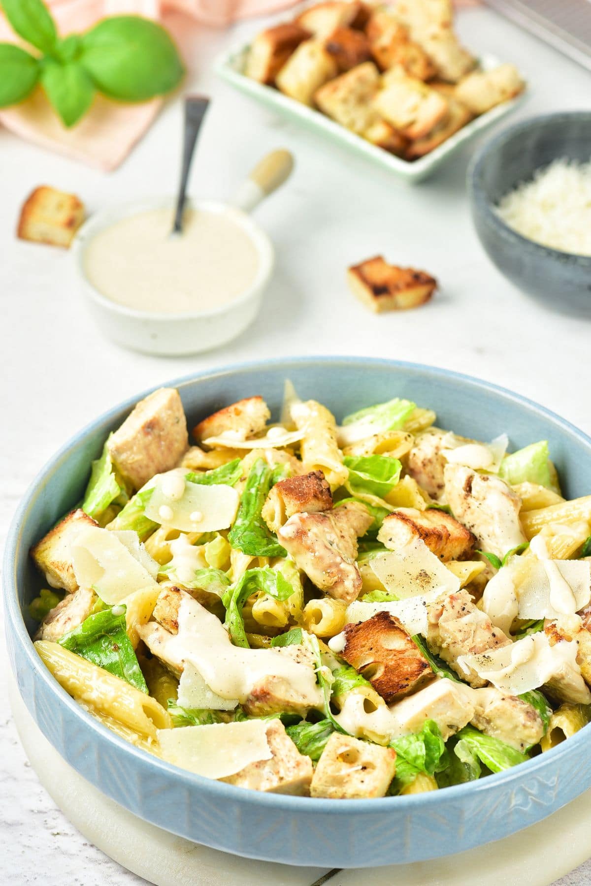 A bowl of chicken pasta salad with caesar dressing