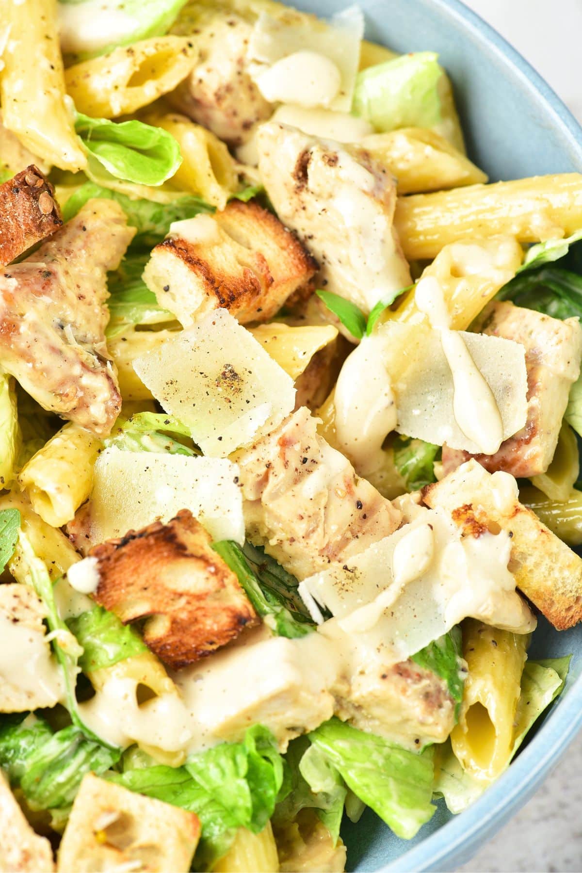 Top down view of a bowl of gluten-free caesar pasta salad