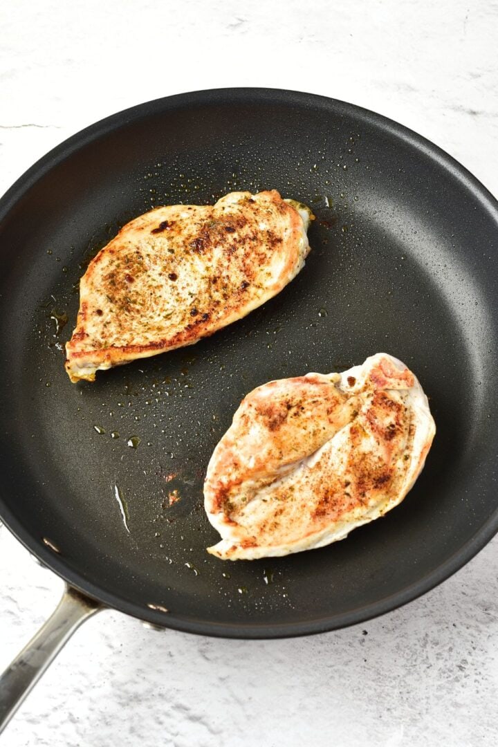Cooked chicken breasts in skillet