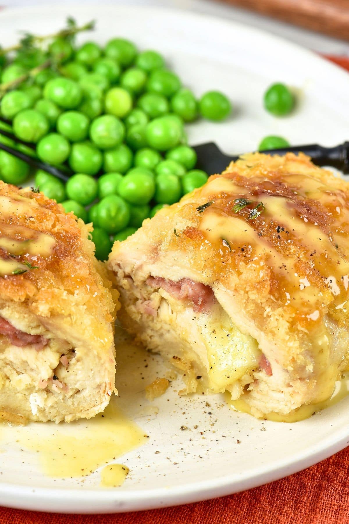 Chicken Cordon Bleu (Gluten-Free) Sliced chicken cordon bleu and peas on a plate