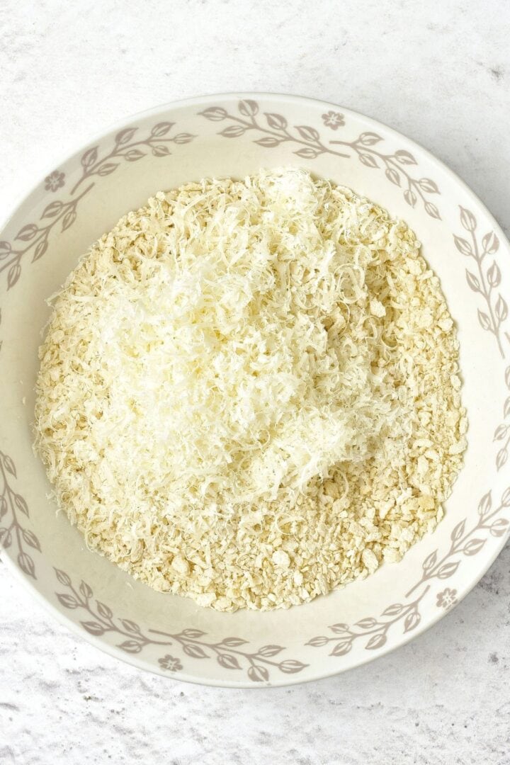 A bowl of gluten-free panko breadcrumbs and freshly grated cheese