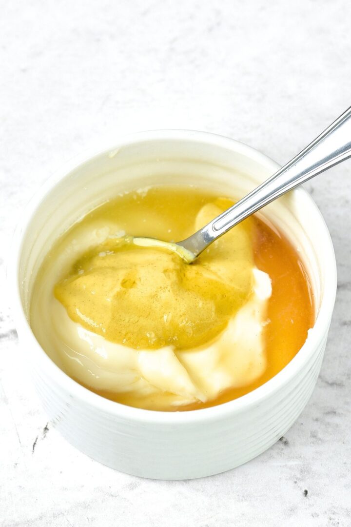 Spoon in a ramekin with mayonnaise, honey, mustard and lemon juice