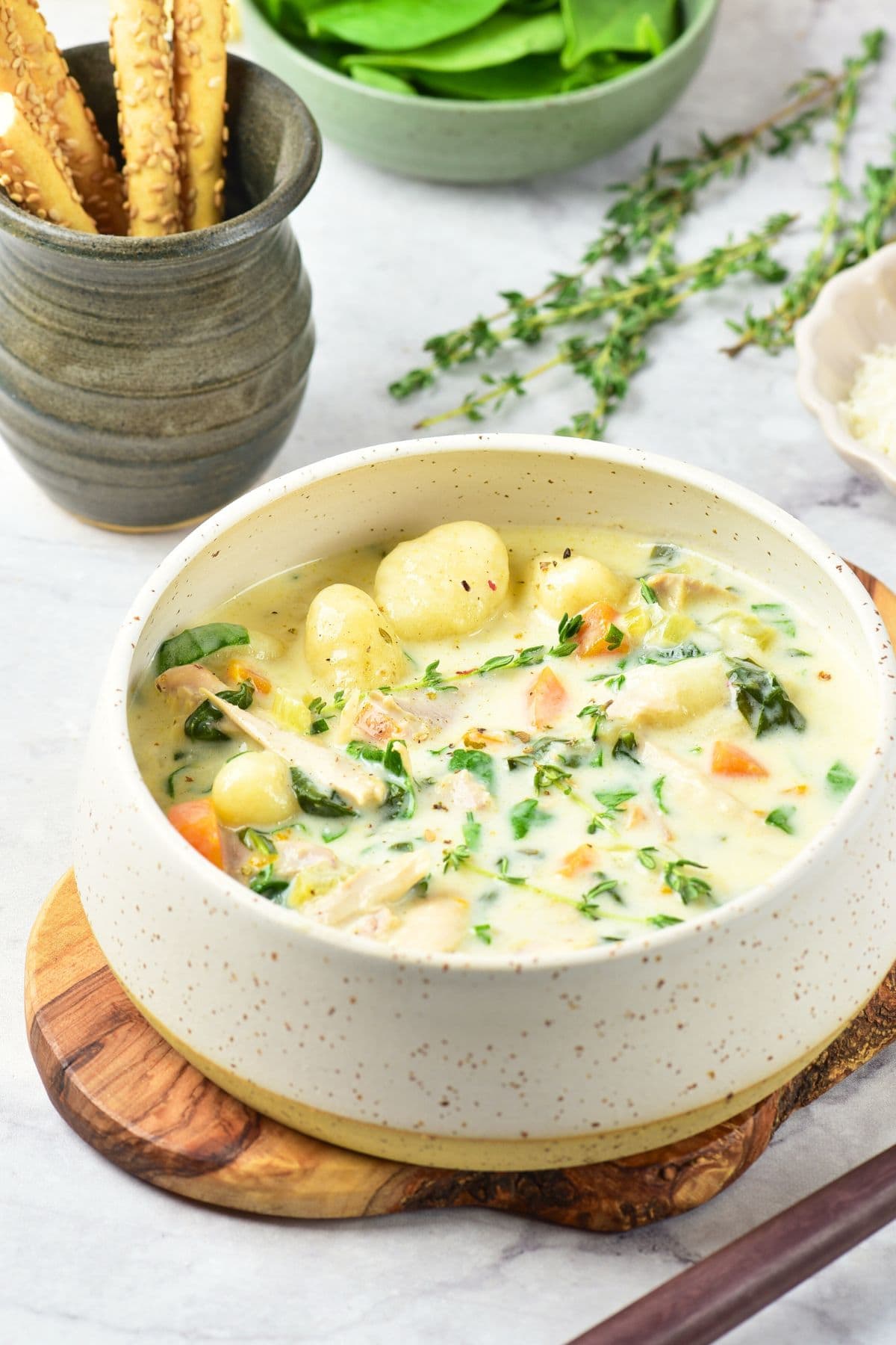 A bowl of creamy chicken soup with gnocchi