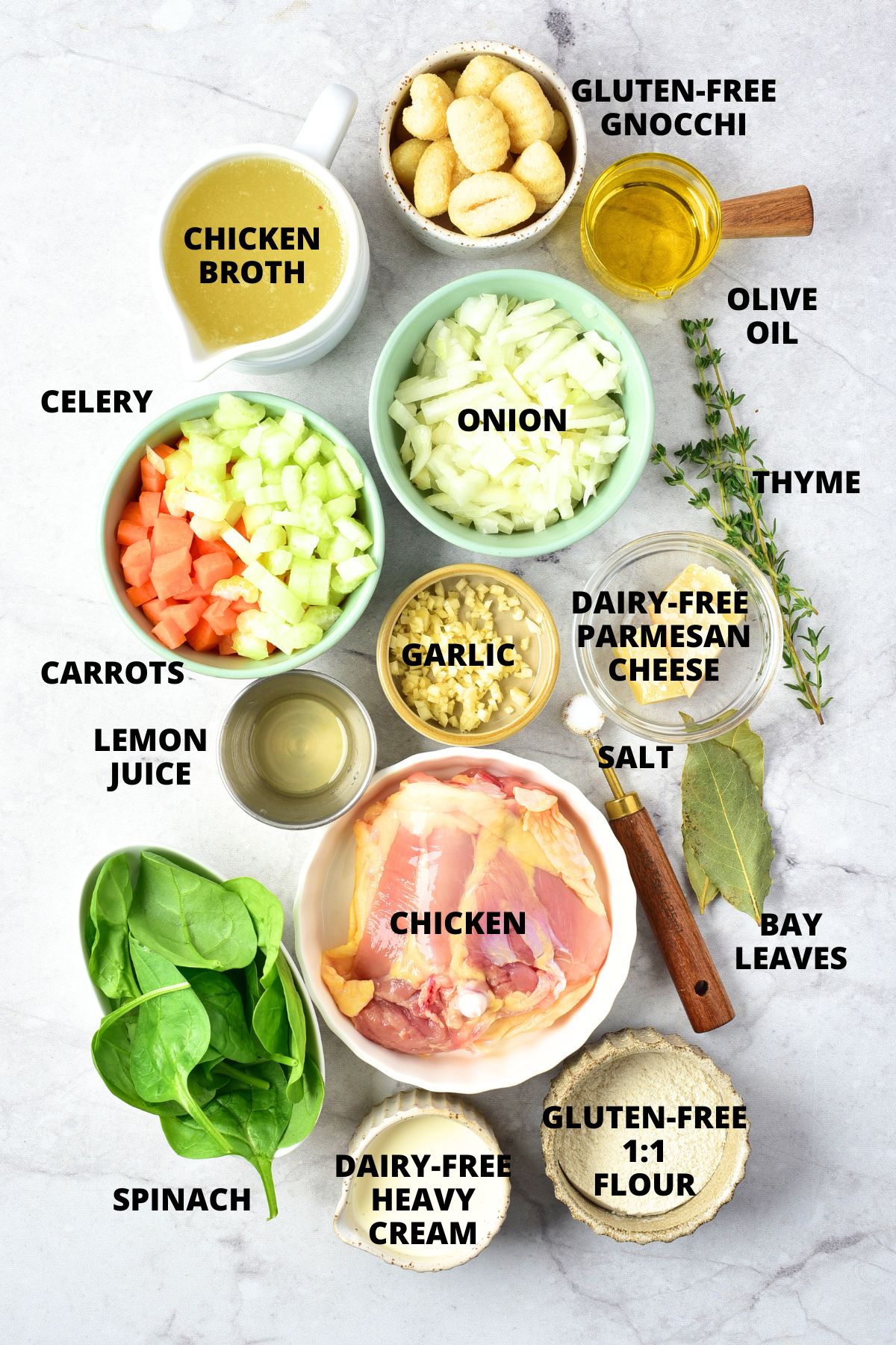 Ingredients for gluten-free chicken gnocchi soup recipe on marble board.