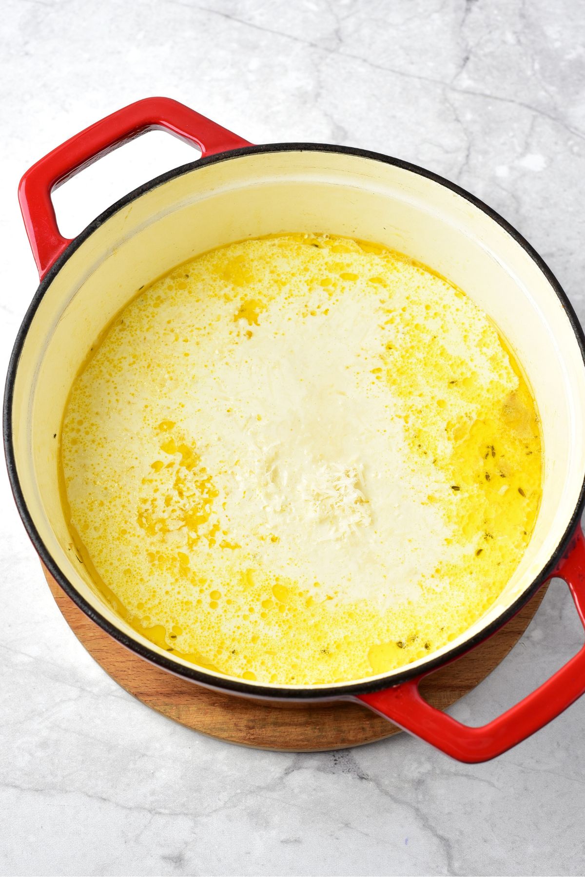 A pot with creamy yellow soup