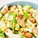 A bowl with chicken caesar pasta salad