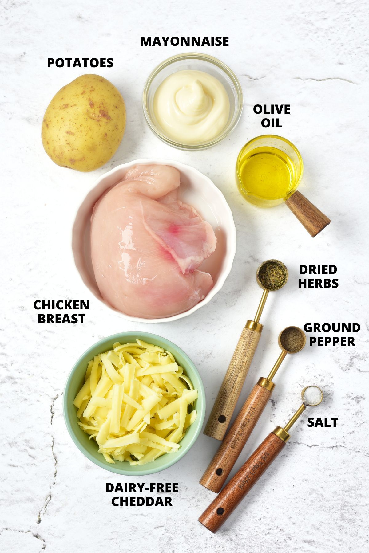 Ingredients for chicken potato bake recipe laid out on marble board.