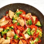 Chicken and vegetable stir fry in skillet