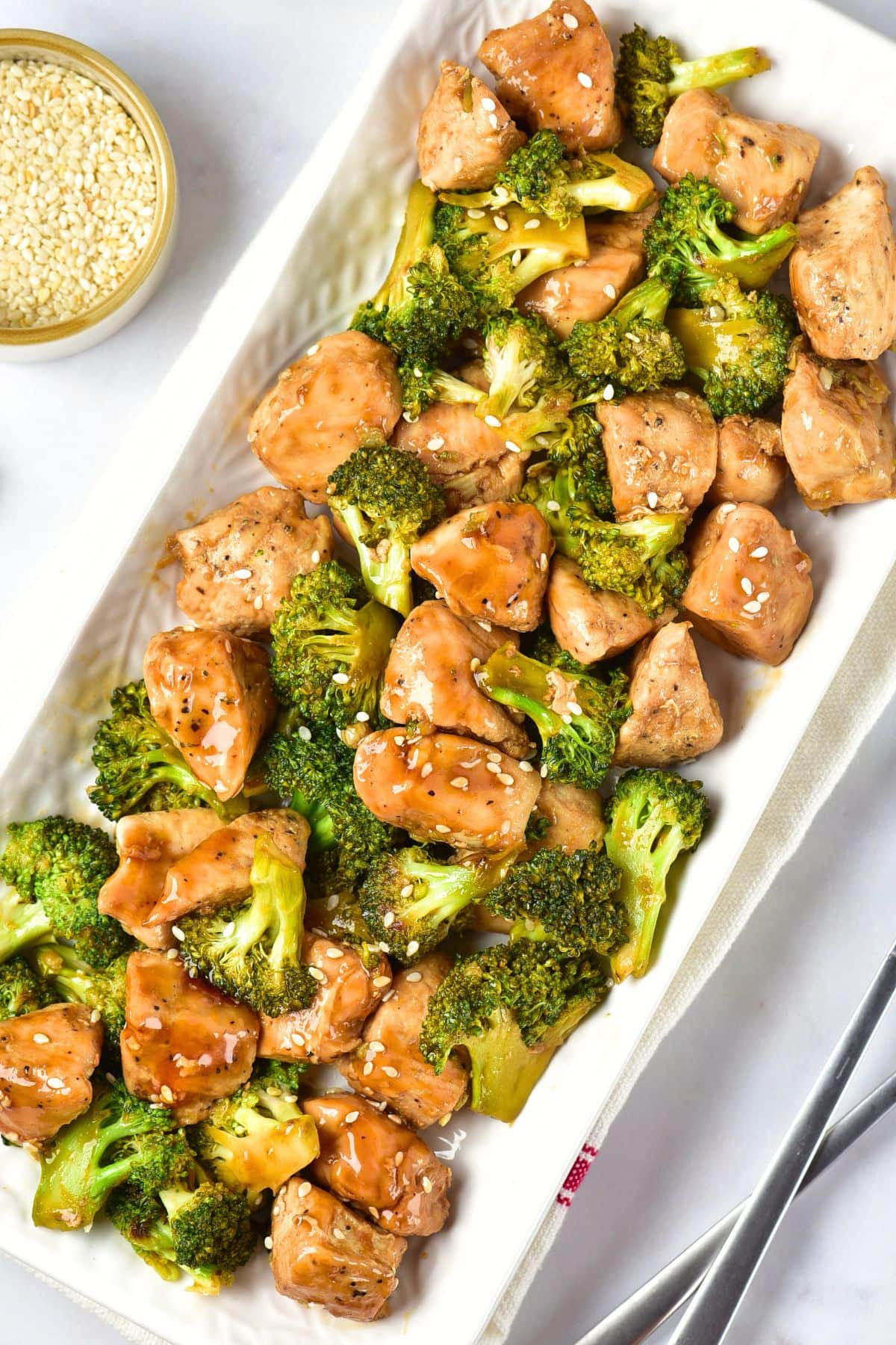 Top down view of a plate of Chinese chicken and broccoli.