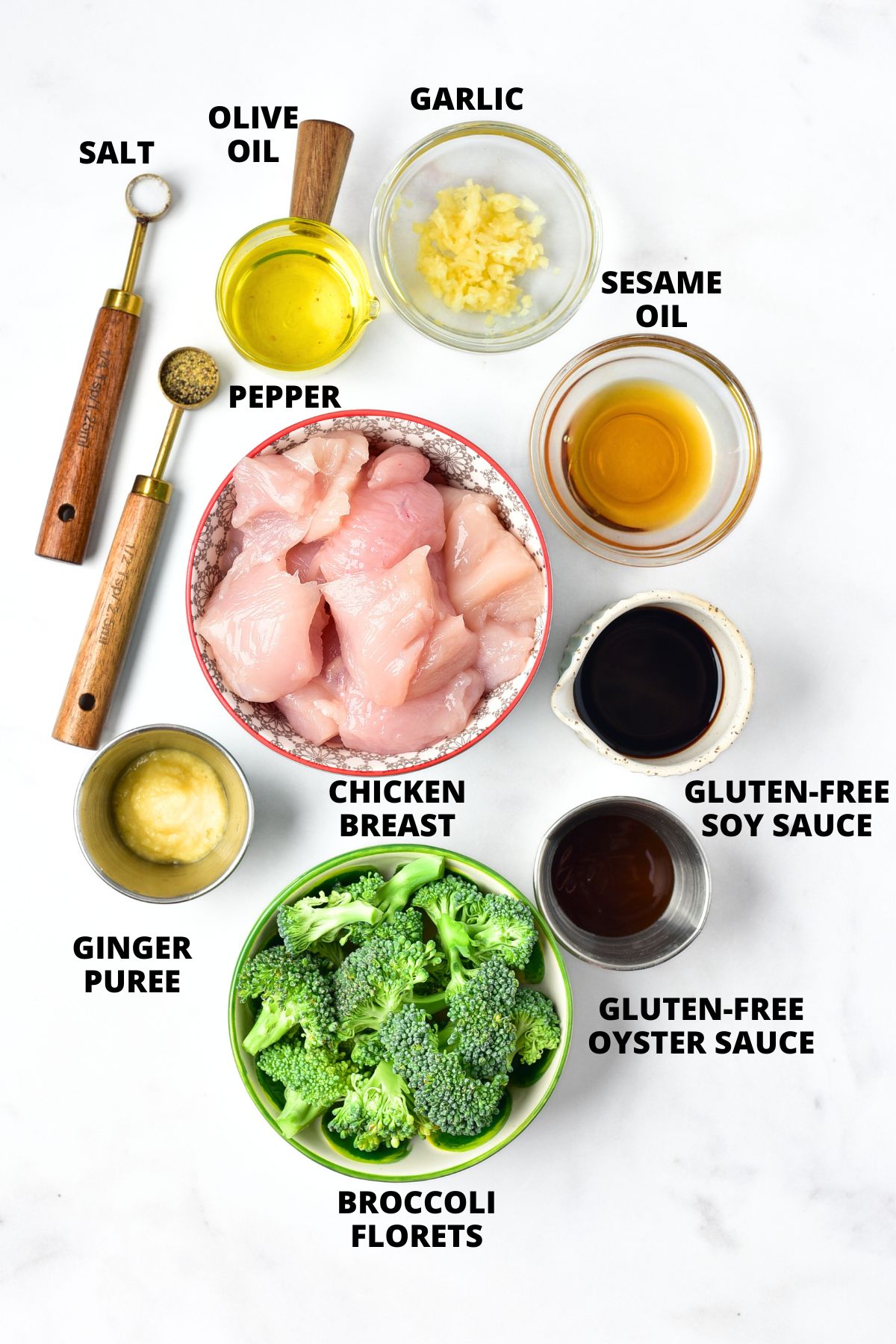 Ingredients for gluten-free chicken and broccoli recipe laid out on marble board.