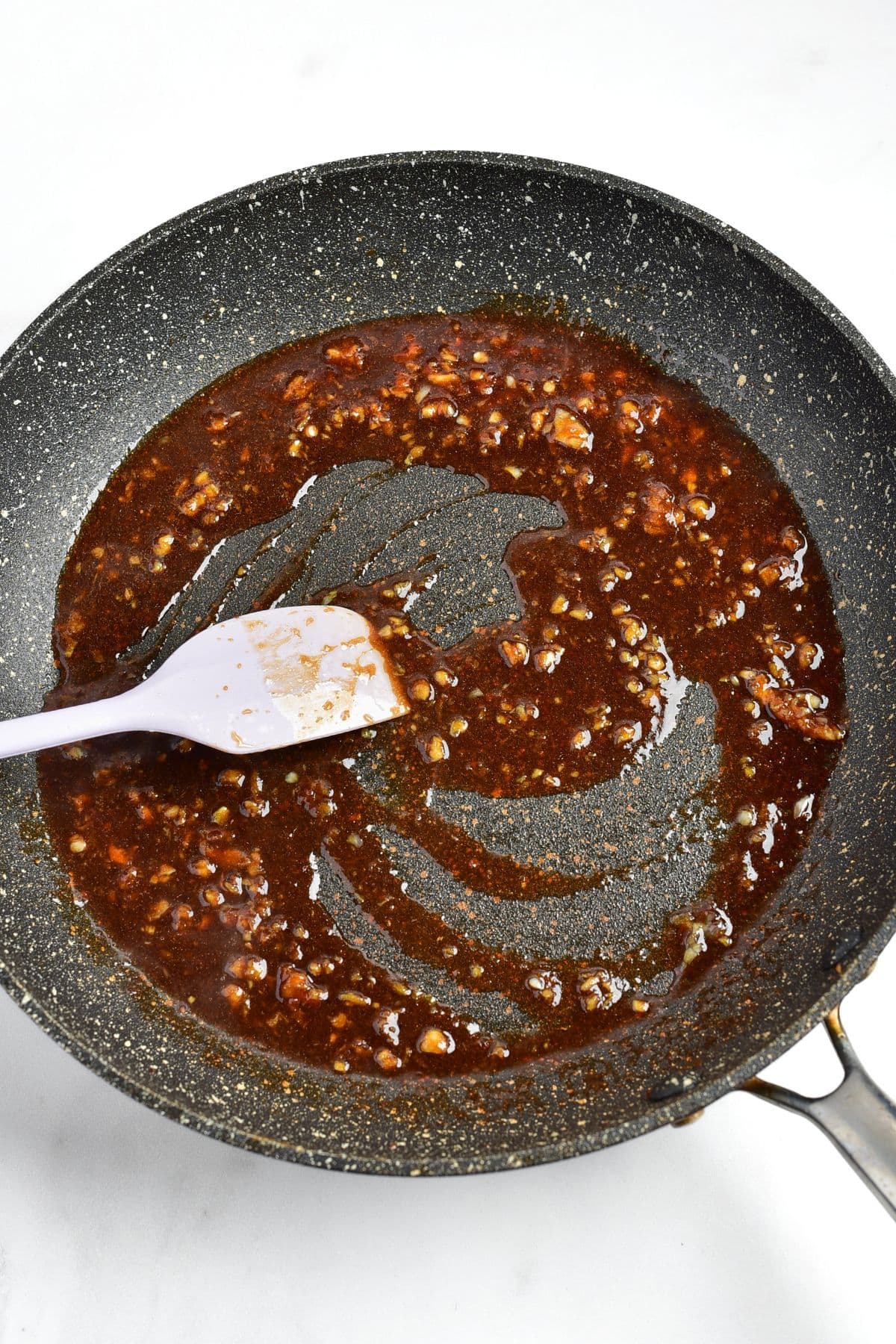 Cooking ginger garlic sauce in skillet.