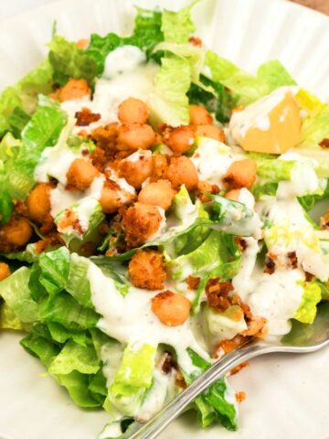 Up close shot of a plate with chickpea caesar salad