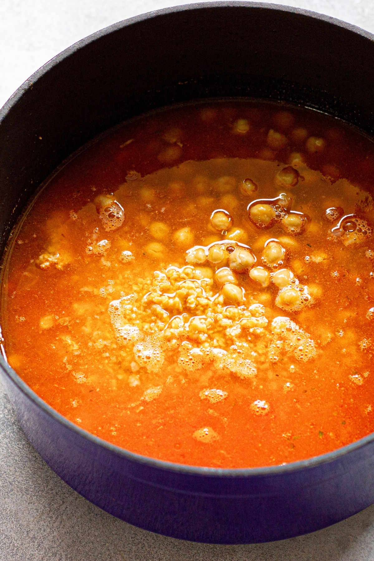 Cooking chickpea soup in pot.