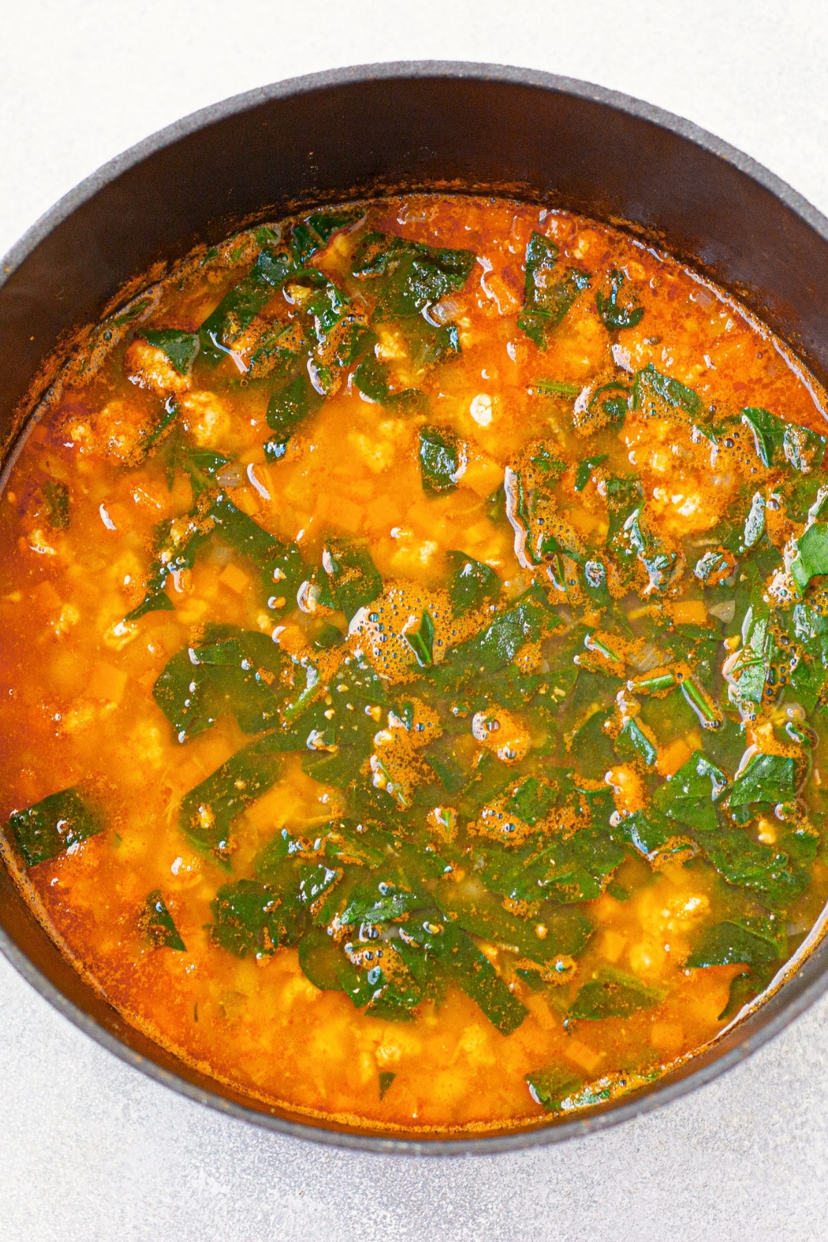 Cooking chickpea kale soup in large pot.