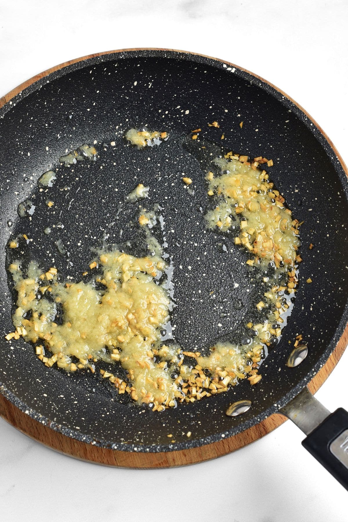 Minced garlic and ginger paste in skillet