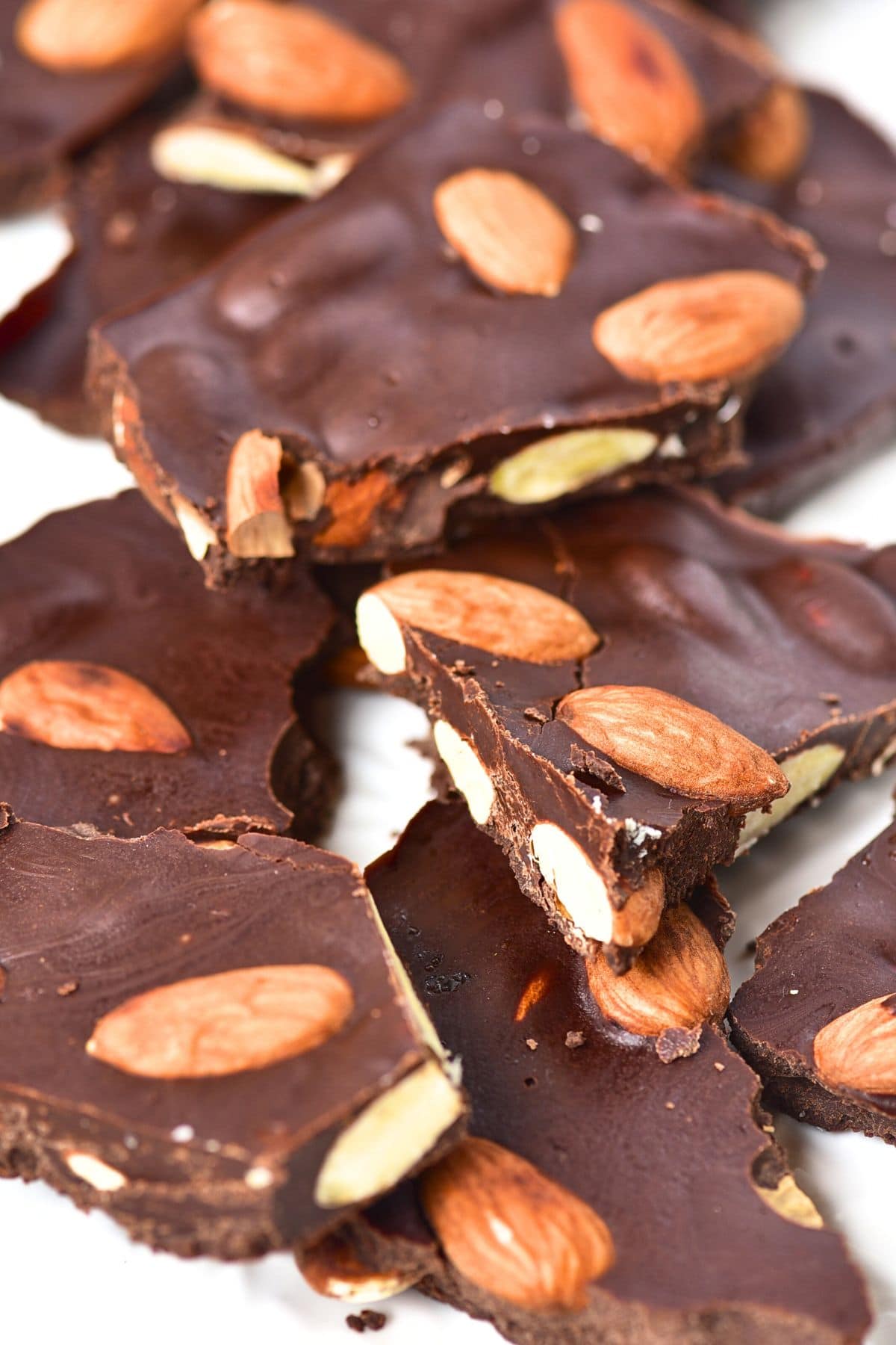 Up close view of almond chocolate bark on plate.