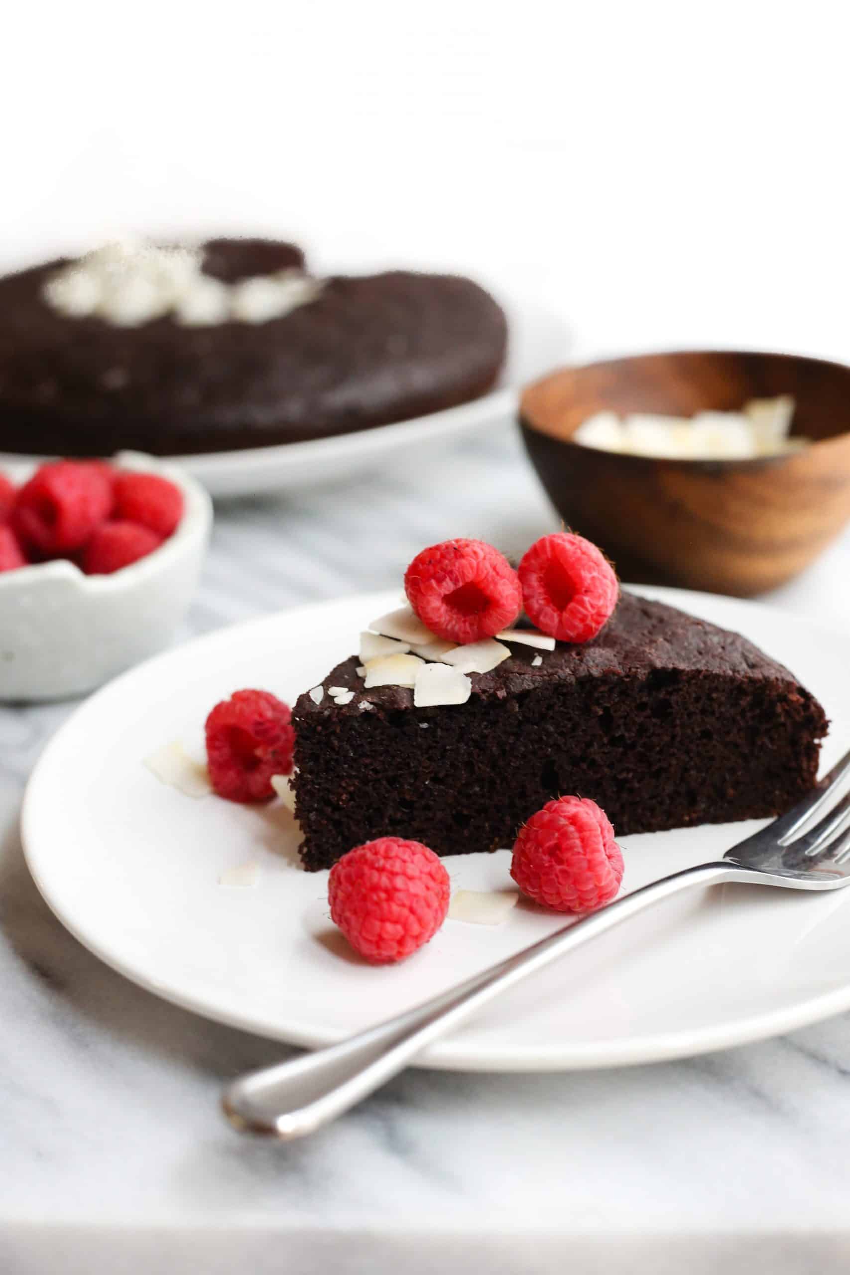 A slice of gluten-free chocolate cake on a small serving plate.