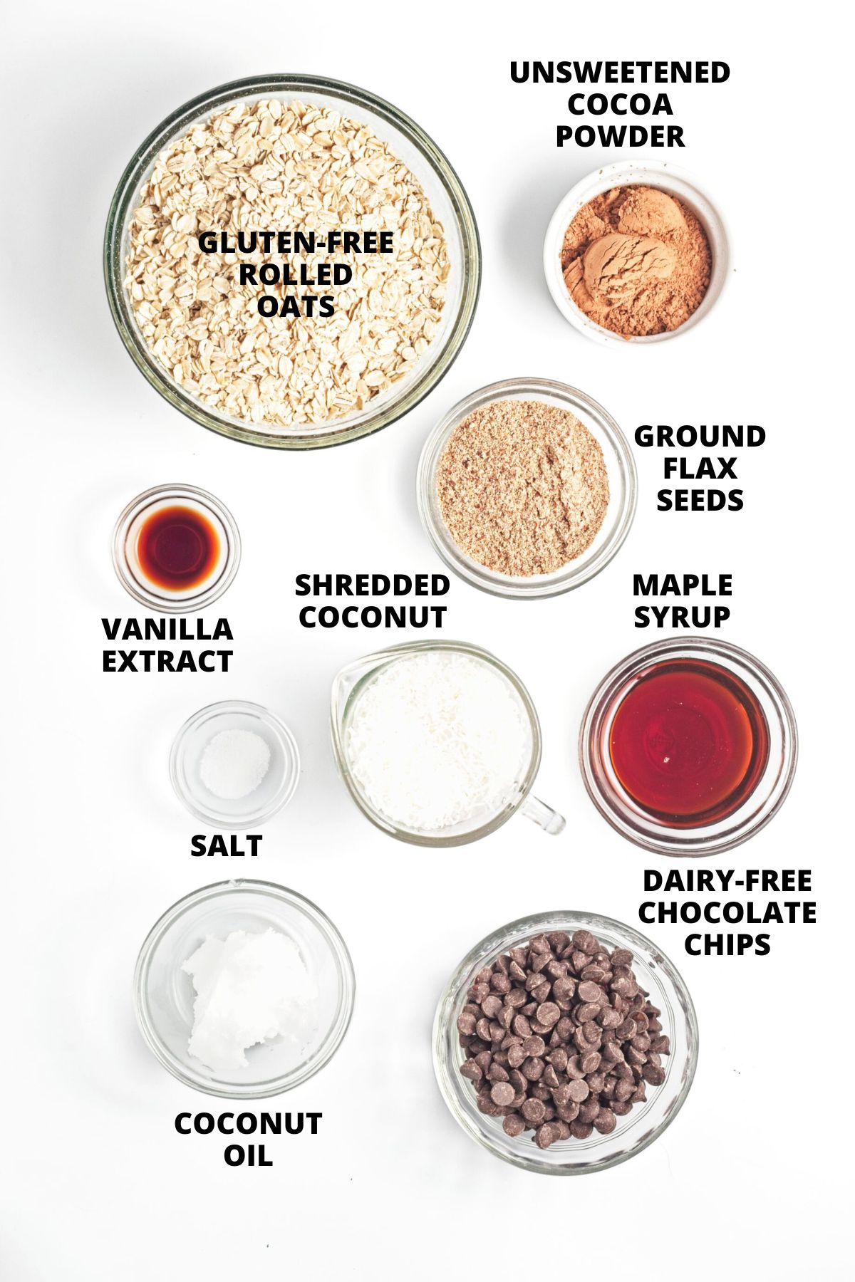 Ingredients for chocolate coconut granola recipe laid out on white board.