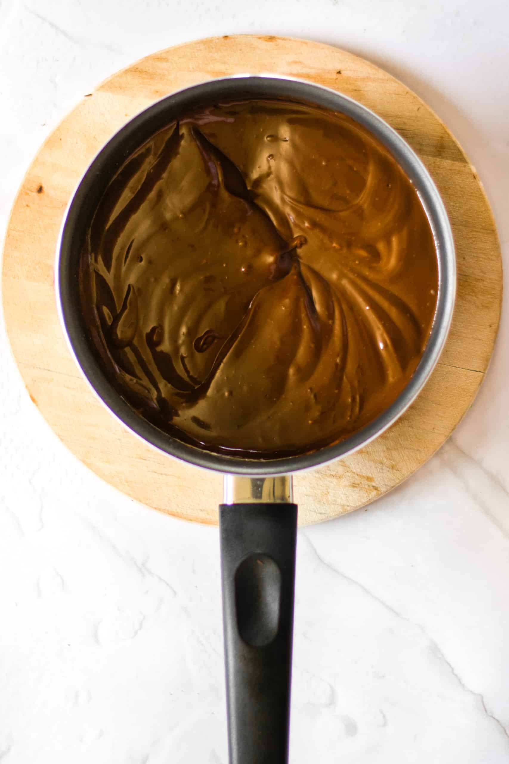 Chocolate ganache filling in a pot.