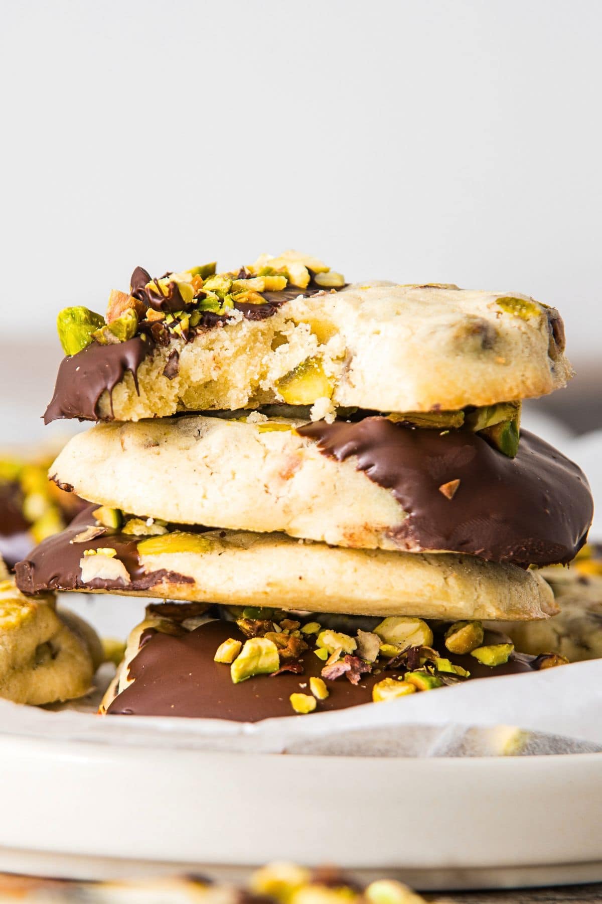 A stack of pistachio cookies dipped in chocolate.