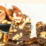 Up close view of stacked chocolate pecan fudge