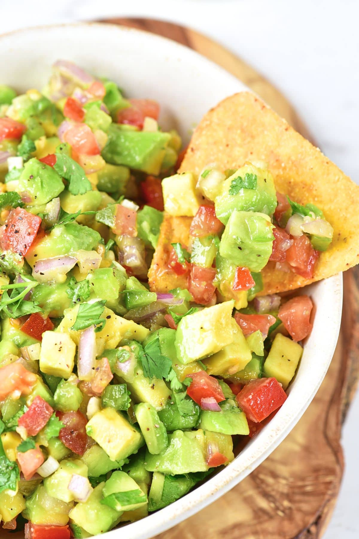 Up close view of a bowl of chunky avocado salsa dip