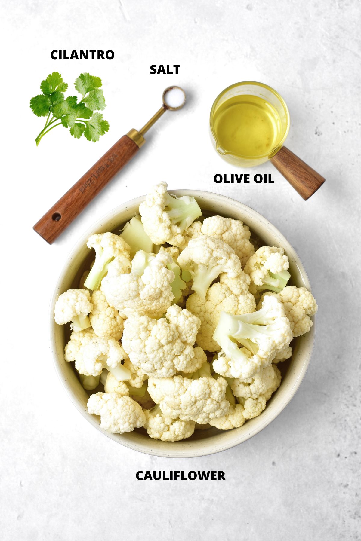 Ingredients for cilantro cauliflower rice recipe laid out on marble boards