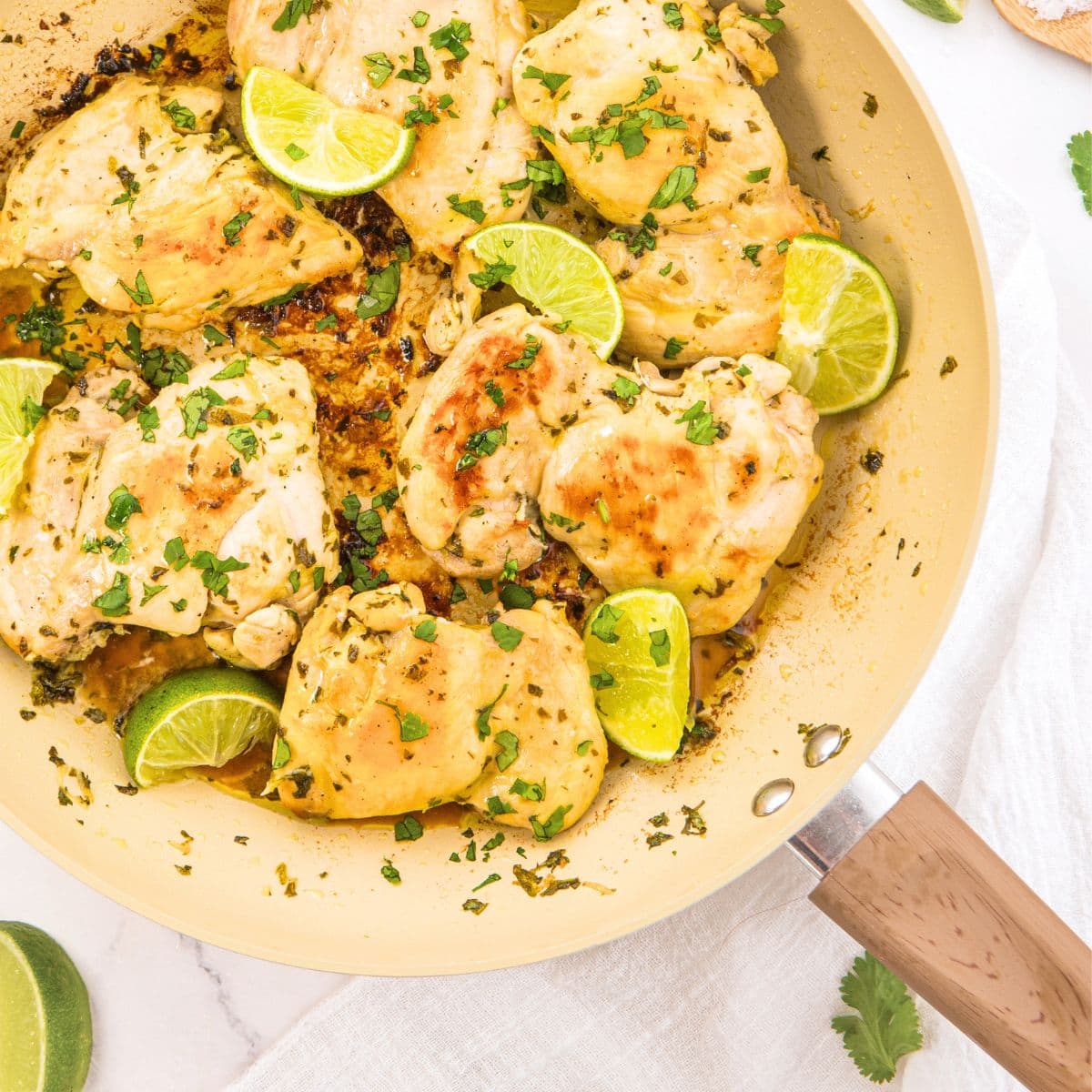 Top down view of cilantro lime chicken thighs in skillet