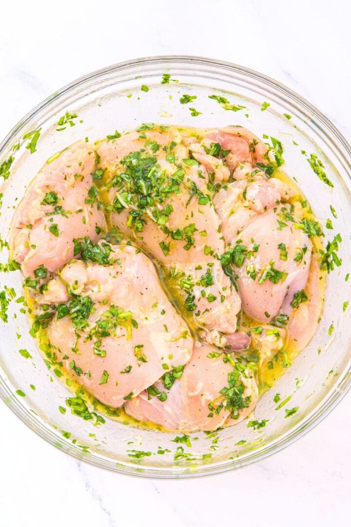 Marinating chicken thighs in a mixture of olive oil, lime juice and cilantro