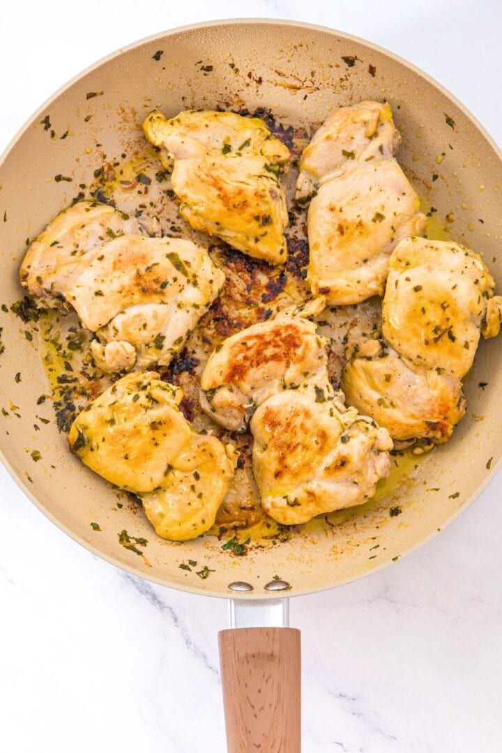 A skillet with gluten-free cilantro lime chicken thighs.