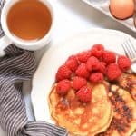 A plate of pancakes and raspberries