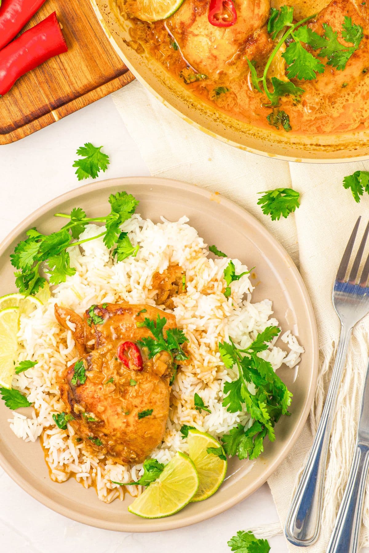 Gluten-Free Coconut Lime Chicken Thighs A plate of gluten-free coconut lime chicken thigh on white rice with fresh cilantro