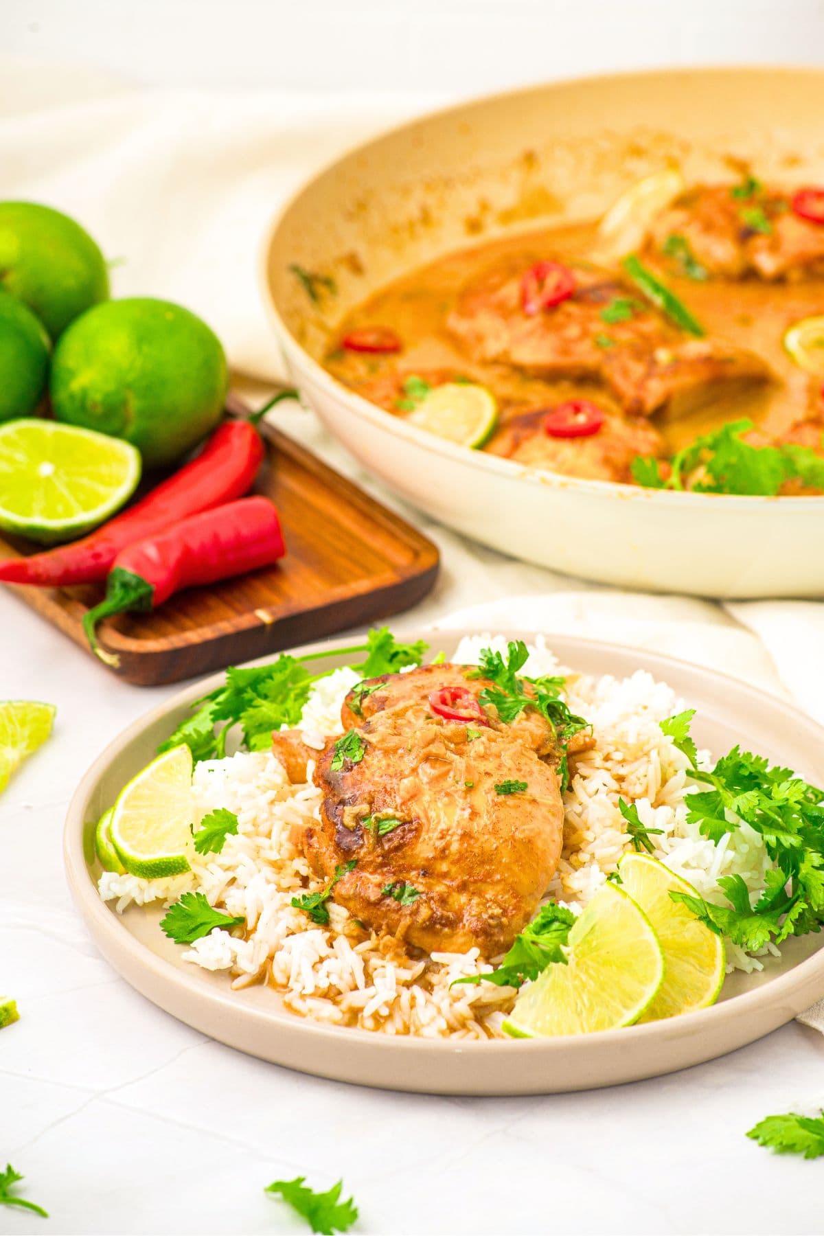 One-Pan Coconut Lime Chicken (Gluten-Free, Dairy-Free) A plate of coconut lime chicken on white rice, lime wedges and fresh cilantro.