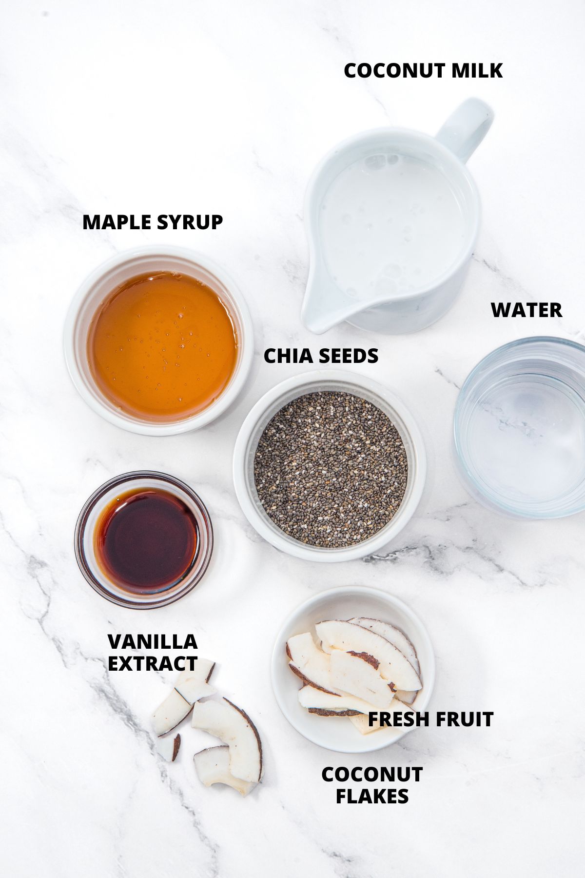 Ingredients for coconut milk chia pudding recipe laid out on marble board.