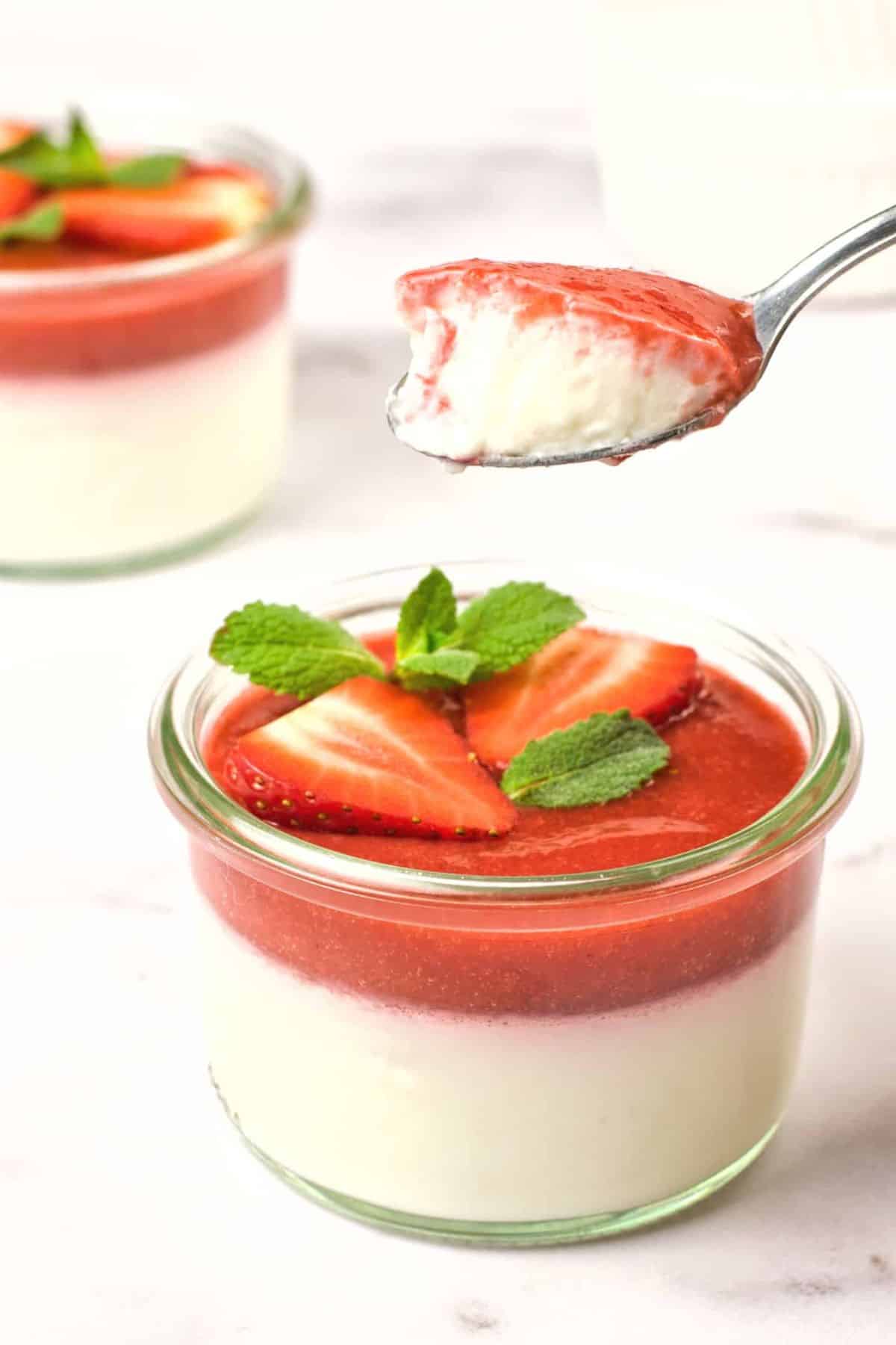 Scooping a spoonful of strawberry coconut panna cotta.