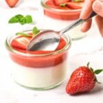 Scooping into vegan panna cotta with strawberry