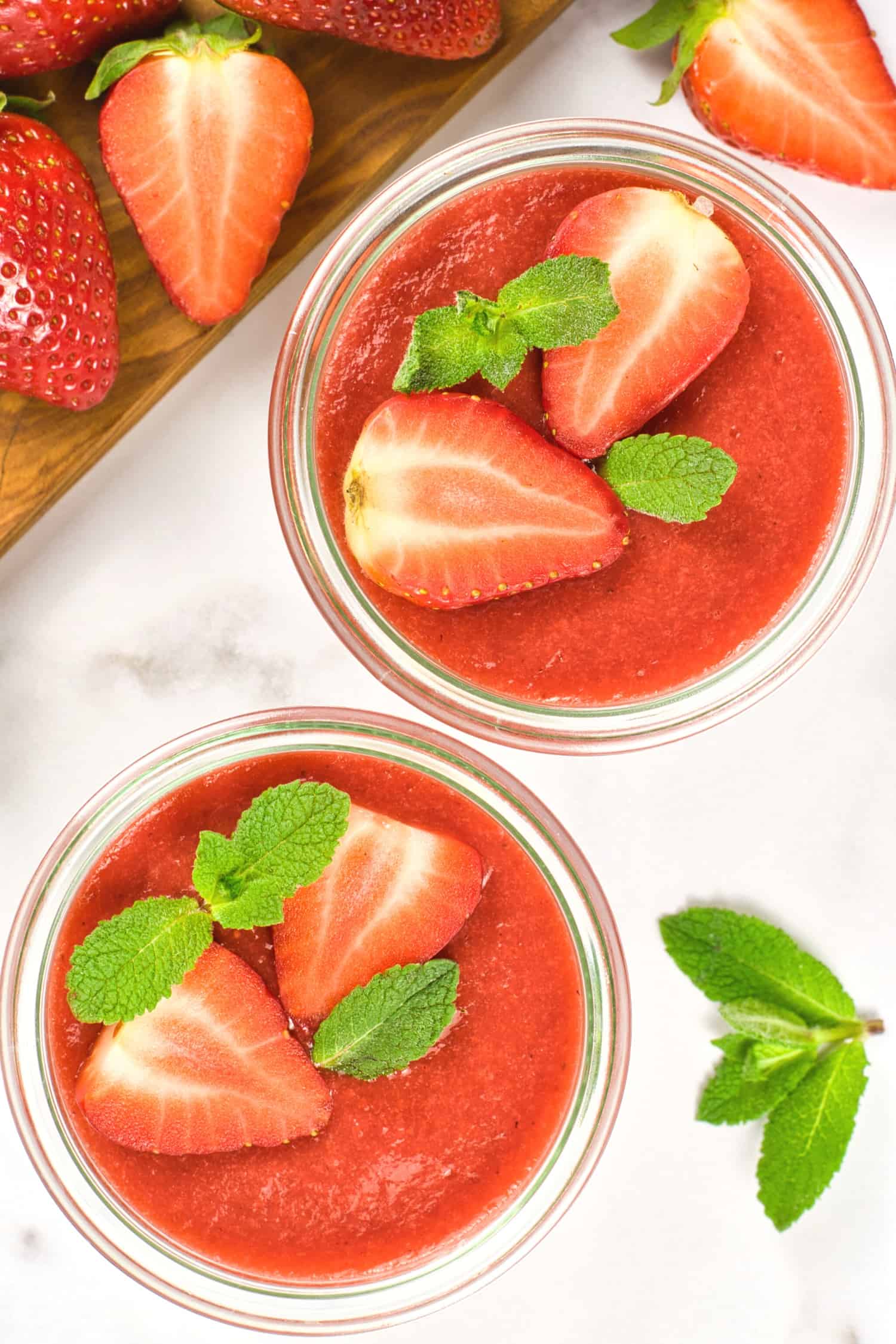 Top down view of strawberry panna cotta in small bowls.