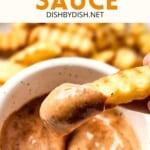 Dipping a crinkle fry into a bowl of cane's sauce.